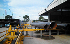 Pipes lined up outside of the pipe building facility at Dril-Quip's Singapore location