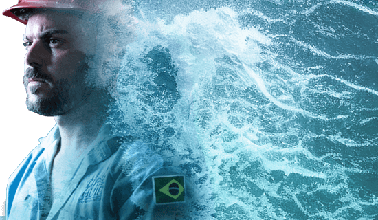 A Brazilian Dril-Quip employee staring off into the distance as his picture fades into crashing waves