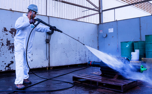 A Dril-Quip employee water blasting production equipment